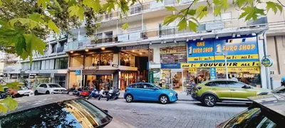 a street with cars parked in front of a building at Danae Luxury Apartment - Rhodes in Rhodes Town
