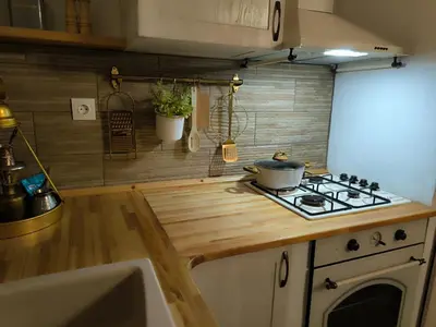 a kitchen with a stove and a counter top at Rustic House Archangelos in Archangelos