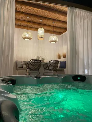 a large tub with green water in a room at Lithos Luxury Villa in Archangelos
