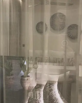 a window with a potted plant in a room at Lithos Luxury Villa in Archangelos