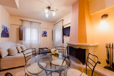 a living room with a glass table and a fireplace at Avalon Boutique Hotel Rhodes in Rhodes Town