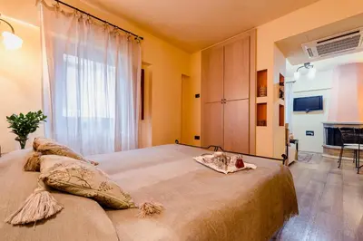 a bedroom with a large bed and a large window at Avalon Boutique Hotel Rhodes in Rhodes Town