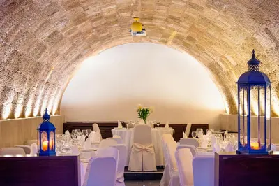 a room with white tables and chairs and a tunnel at Avalon Boutique Hotel Rhodes in Rhodes Town