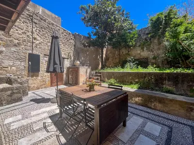 a patio with an umbrella and a table and chairs at Avalon Boutique Hotel Rhodes in Rhodes Town