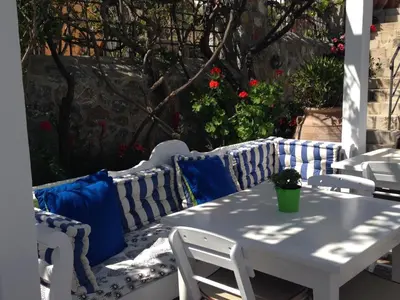 a white table and chairs on a patio at Melenos Art Boutique Hotel in Líndos