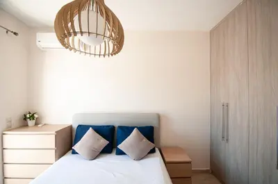 a bedroom with a bed and a chandelier at Saint Francis Apartment in Rhodes Town