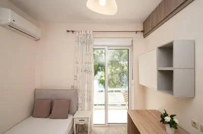 a small room with a bed and a window at Saint Francis Apartment in Rhodes Town
