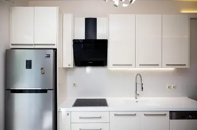 a kitchen with white cabinets and a stainless steel refrigerator at Saint Francis Apartment in Rhodes Town