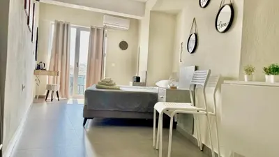 a bedroom with a bed and a table and chairs at Sea Side Rooms in Rhodes Town