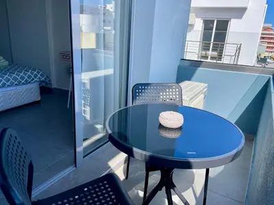 a hat sitting on a table on a balcony at Sea Side Rooms in Rhodes Town