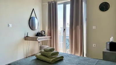 a room with a mirror and a table with towels at Sea Side Rooms in Rhodes Town