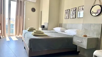 a bedroom with a large bed with towels on it at Sea Side Rooms in Rhodes Town