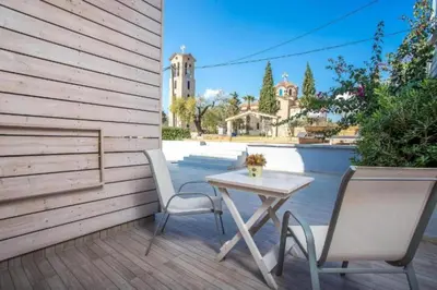a table and two chairs on a patio at Pagona Studios in Faliraki