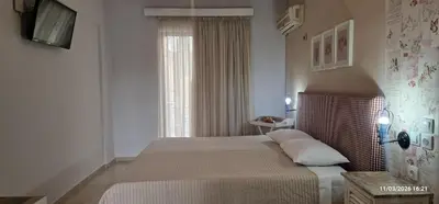 a bedroom with a large bed and a window at Pagona Studios in Faliraki