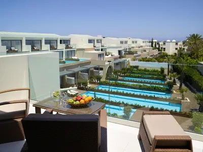 an apartment balcony with a view of a swimming pool at The Ixian Grand & All Suites - Adults Only Hotel in Ixia