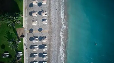 an overhead view of a beach with parked cars at The Ixian Grand & All Suites - Adults Only Hotel in Ixia
