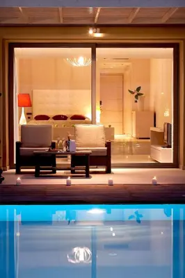 a living room with a couch and a table at The Ixian Grand & All Suites - Adults Only Hotel in Ixia