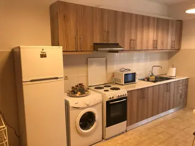 a kitchen with a refrigerator and a washing machine at Jacob Apartments in Center of Rhodes in Rhodes Town