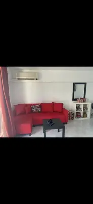 a living room with a red couch and a table at Jacob Apartments in Center of Rhodes in Rhodes Town