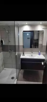 a bathroom with a shower and a sink and a mirror at Jacob Apartments in Center of Rhodes in Rhodes Town