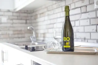 a bottle of wine sitting on a counter in a kitchen at Nitsa Studio in Faliraki