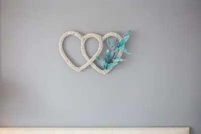 a heart shaped decoration on a white wall at Nitsa Studio in Faliraki