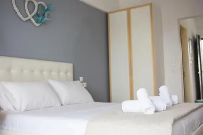 a white bed with two rolls of towels on it at Nitsa Studio in Faliraki