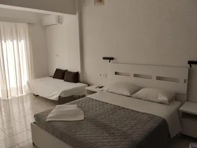 a bedroom with two beds in a room at Palma Apartment in Faliraki