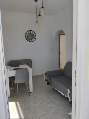 a living room with a couch and a table at Palma Apartment in Faliraki