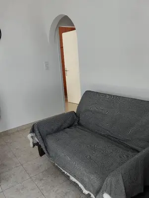 a bed sitting in a room with a door at Palma Apartment in Faliraki