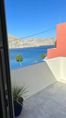 a view of the water from a balcony at Amalthea Luxury Suites in Symi