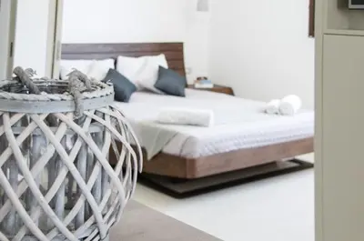 a bedroom with a large bed with a basket at Helen Superior Suite in Líndos
