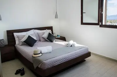 a bedroom with a bed with a hat on it at Helen Superior Suite in Líndos