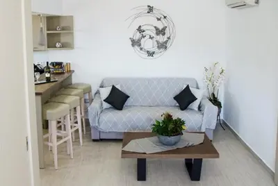 a living room with a couch and a table at Helen Superior Suite in Líndos