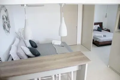 a living room with a couch and a table with pillows at Helen Superior Suite in Líndos
