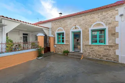 a brick house with a parking lot in front of it at Rhodes Heaven Rose in Malona Village