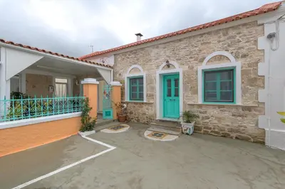 a brick house with blue doors and a patio at Rhodes Heaven Rose in Malona Village