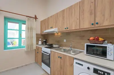 a kitchen with a sink and a microwave at Rhodes Heaven Rose in Malona Village