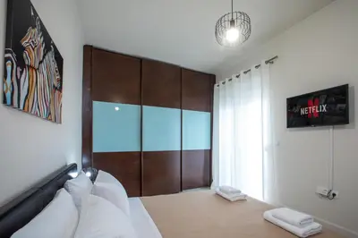 a bedroom with a large wooden closet and a bed at Christina's House in Afantou