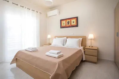 a bedroom with a large bed with towels on it at Christina's House in Afantou
