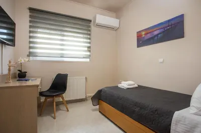 a bedroom with a bed and a desk and a chair at Christina's House in Afantou