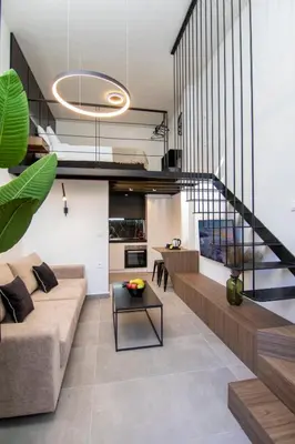 a living room with a couch and a staircase at Luxury Loft in the center in Rhodes Town