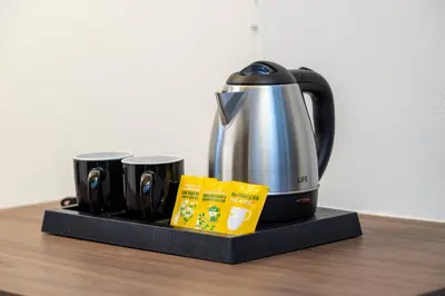 a tea kettle and two mugs on a black tray at Luxury Loft in the center in Rhodes Town