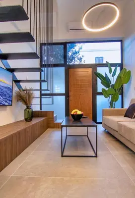 a living room with a staircase and a table at Luxury Loft in the center in Rhodes Town