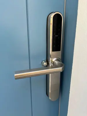 a silver door handle on a blue door at Aleminas Rooms 1 in Symi