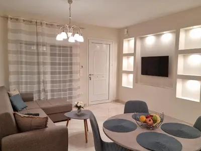 a living room with a table with a bowl of fruit on it at Ma Maison Bleue in Kremasti