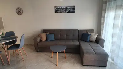 a living room with a couch and a table at Ma Maison Bleue in Kremasti