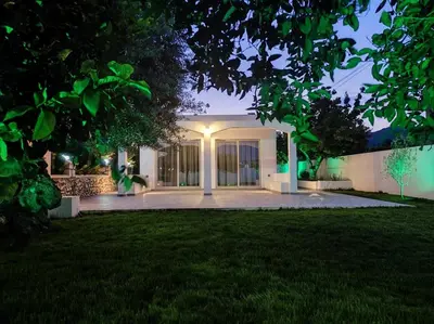 a house with a lawn in front of it at Rhodes Soul Luxury Suites in Afantou