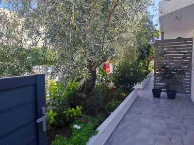 a garden with a tree and a fence at Rhodes Soul Luxury Suites in Afantou
