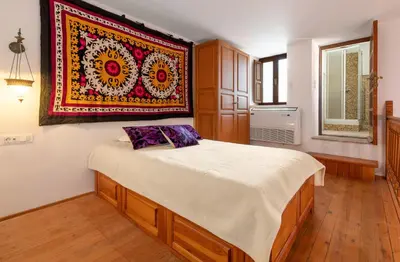 a bedroom with a bed with a rug on the wall at Villa Venetoklis in Líndos